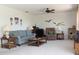 Inviting living room with neutral carpeting, comfortable seating, and ample natural light at 2467 Herron Ter, Port Charlotte, FL 33981