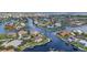 A captivating aerial view showcases waterfront homes with private docks along scenic canals in a residential community at 250 Freeport Ct, Punta Gorda, FL 33950