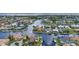Scenic aerial captures a network of waterfront homes, offering a glimpse of upscale coastal community at 250 Freeport Ct, Punta Gorda, FL 33950