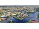 Scenic aerial view of waterfront homes with private docks along canals in a residential community with lush landscaping at 250 Freeport Ct, Punta Gorda, FL 33950