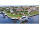 Aerial view of canal-front home with a private dock and boat lift surrounded by lush landscaping at 250 Freeport Ct, Punta Gorda, FL 33950