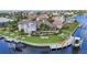 Aerial view of a waterfront home featuring a pool, lush landscaping, boat lifts and a private dock at 250 Freeport Ct, Punta Gorda, FL 33950