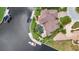 An aerial view of a waterfront home boasts a backyard pool, boat dock, and mature landscaping at 250 Freeport Ct, Punta Gorda, FL 33950