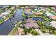 Stunning aerial view of a waterfront home with a private dock and lush tropical landscaping at 250 Freeport Ct, Punta Gorda, FL 33950