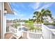 Relaxing balcony view, featuring waterfront vistas and comfortable white Adirondack chairs at 250 Freeport Ct, Punta Gorda, FL 33950