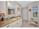 Bright bathroom featuring a granite countertop vanity and tiled shower with curtain at 250 Freeport Ct, Punta Gorda, FL 33950