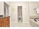Bathroom featuring a bathtub, walk-in shower, dark countertops, and wooden cabinets at 250 Freeport Ct, Punta Gorda, FL 33950