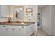 Bathroom showcasing a granite vanity with white cabinets and decorative mirror at 250 Freeport Ct, Punta Gorda, FL 33950