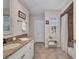 Bright bathroom featuring a granite countertop vanity and tiled shower with curtain at 250 Freeport Ct, Punta Gorda, FL 33950