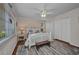 Nautical-themed bedroom with a large bed, ceiling fan, and wood-look floors at 250 Freeport Ct, Punta Gorda, FL 33950