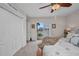 Cozy bedroom featuring a ceiling fan and sliding glass doors with a beautiful water view at 250 Freeport Ct, Punta Gorda, FL 33950