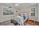 Cozy bedroom with wood floors, natural light, and nautical decor at 250 Freeport Ct, Punta Gorda, FL 33950