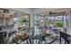 Bright dining area featuring a glass table with views of the pool, patio and manicured landscaping at 250 Freeport Ct, Punta Gorda, FL 33950