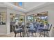 Bright dining area featuring a glass table and sliding glass doors with views of the pool and patio at 250 Freeport Ct, Punta Gorda, FL 33950