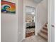 Hallway view of the bedroom featuring an area rug, white furniture and staircase at 250 Freeport Ct, Punta Gorda, FL 33950