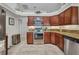Well-appointed kitchen featuring granite countertops, stainless steel appliances, and classic wood cabinetry at 250 Freeport Ct, Punta Gorda, FL 33950