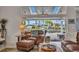 Relaxing lanai featuring comfortable seating and a view of the landscaped backyard and canal at 250 Freeport Ct, Punta Gorda, FL 33950