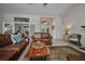 Comfortable living room featuring leather sofas, a unique coffee table, and a view of the front entrance at 250 Freeport Ct, Punta Gorda, FL 33950