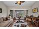 Cozy living room with hardwood floors, bay window, and vintage furniture at 250 Freeport Ct, Punta Gorda, FL 33950