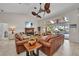 Open-concept living room featuring leather furniture, a fireplace, and a view of the lanai and pool at 250 Freeport Ct, Punta Gorda, FL 33950