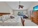 Bright main bedroom with a ceiling fan and a view of the pool and patio area at 250 Freeport Ct, Punta Gorda, FL 33950