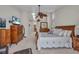 Spacious main bedroom featuring a ceiling fan, wooden furniture, and carpeted floors at 250 Freeport Ct, Punta Gorda, FL 33950