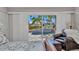 View from the bed to a seating area and a view of the backyard pool at 250 Freeport Ct, Punta Gorda, FL 33950