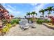 Outdoor patio with pavers, perfect for entertaining and relaxing, surrounded by tropical plants at 250 Freeport Ct, Punta Gorda, FL 33950