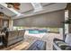 A covered patio with retractable shades, providing privacy and sun protection overlooking pool at 250 Freeport Ct, Punta Gorda, FL 33950