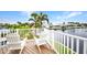 Relaxing patio with two white chairs overlooking the tranquil waterfront at 250 Freeport Ct, Punta Gorda, FL 33950