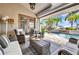 A cozy outdoor patio area with comfortable seating and a view of the pool at 250 Freeport Ct, Punta Gorda, FL 33950