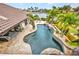 An aerial view of a beautiful backyard pool with palm trees and a waterfront view at 250 Freeport Ct, Punta Gorda, FL 33950