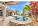 A cozy backyard spa surrounded by tropical plants and stylish patio furniture at 250 Freeport Ct, Punta Gorda, FL 33950