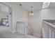 Hallway with a view of the staircase and bedroom with skylight overhead at 250 Freeport Ct, Punta Gorda, FL 33950