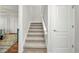 Carpeted stairs with white handrail leading to the upper level of the home at 250 Freeport Ct, Punta Gorda, FL 33950