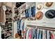 Well-organized walk-in closet with shelves and hanging rods filled with clothes, shoes, and accessories at 250 Freeport Ct, Punta Gorda, FL 33950