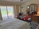Bedroom featuring natural light, sliding glass door and basic furnishing at 26312 Deep Creek Blvd, Punta Gorda, FL 33983