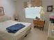 Cozy bedroom featuring a comfortable bed, side tables and natural light at 26312 Deep Creek Blvd, Punta Gorda, FL 33983