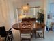 Traditional dining room with wood table, chairs, chandelier, and large window at 26312 Deep Creek Blvd, Punta Gorda, FL 33983