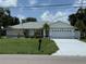Charming single story home featuring an attached two-car garage and a well-manicured front lawn at 26312 Deep Creek Blvd, Punta Gorda, FL 33983