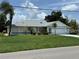 Charming single story home featuring an attached two-car garage and a well-manicured front lawn at 26312 Deep Creek Blvd, Punta Gorda, FL 33983