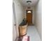 Inviting foyer with a decorative cabinet, tile flooring, and a charming front door with a half-moon window at 26312 Deep Creek Blvd, Punta Gorda, FL 33983
