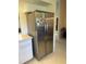 Stainless steel refrigerator with water dispenser, alongside white cabinets in this kitchen at 26312 Deep Creek Blvd, Punta Gorda, FL 33983