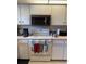 Functional kitchen with white cabinets and modern appliances at 26312 Deep Creek Blvd, Punta Gorda, FL 33983