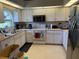 Functional kitchen with white cabinets, modern appliances, and a view to the outdoors at 26312 Deep Creek Blvd, Punta Gorda, FL 33983