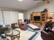 Spacious living room featuring a ceiling fan, a skylight, and neutral-colored walls at 26312 Deep Creek Blvd, Punta Gorda, FL 33983