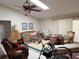 Spacious living room featuring a ceiling fan, a skylight, and neutral-colored walls at 26312 Deep Creek Blvd, Punta Gorda, FL 33983