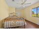 Bright bedroom with a ceiling fan, closet, and a window with a view of the outdoors at 264 Rotonda N Blvd, Rotonda West, FL 33947