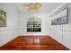 Cozy bedroom with hardwood floors, a ceiling fan, and a window with natural light at 264 Rotonda N Blvd, Rotonda West, FL 33947
