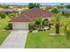 Charming single Gathering home featuring a well manicured lawn and beautifully landscaped yard with a large driveway at 264 Rotonda N Blvd, Rotonda West, FL 33947
